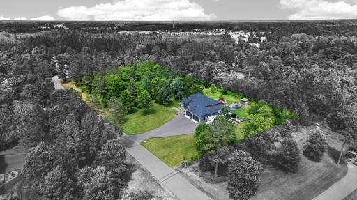 Approximate property boundaries shown. 2.5 acres with established landscaping, open lawn, and wooded surroundings.