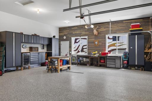 Insulated four-stall garage with epoxy floors and built-in storage.