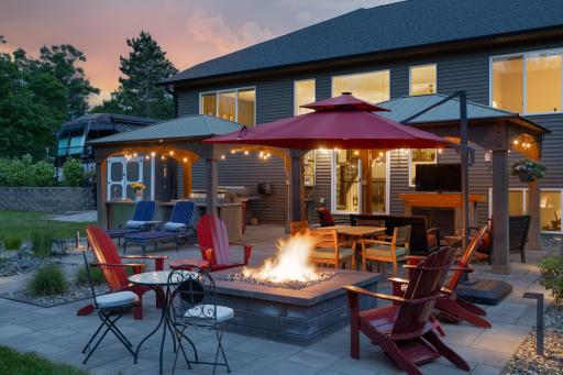 Natural gas fire table surrounded by paver patios.