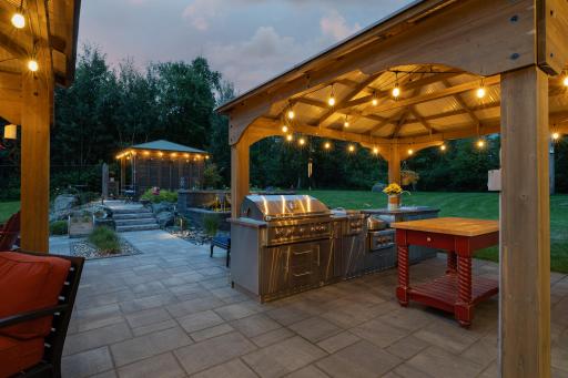 Gazebo with outdoor kitchen, water feature, hot tub gazebo, and paver patios create an exceptional setting for entertaining.