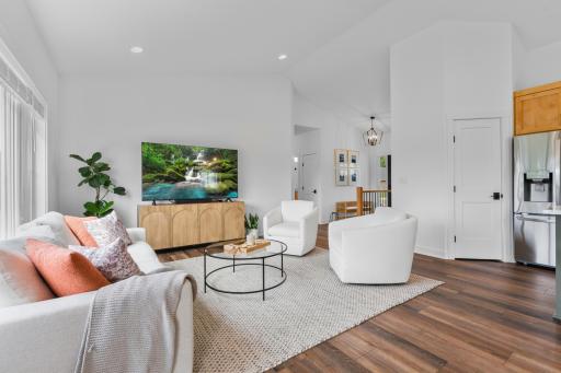 Large windows, vaulted ceilings and an open floor plan create an inviting space.