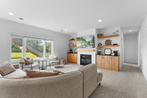 Tasteful built in shelves and cabinets flank the fireplace.