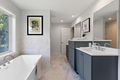The primary bathroom includes a large soaking tub, dual vanity and massive walk-in shower!