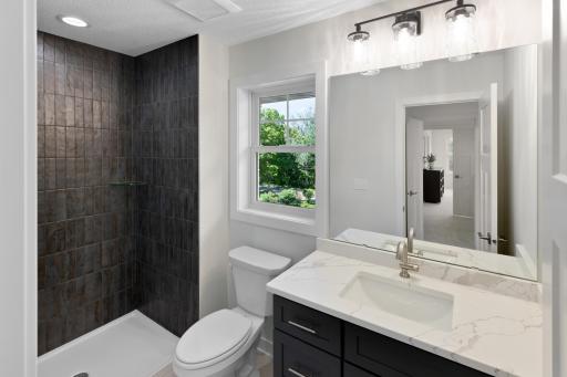 3/4 bathroom with tiled shower in bedroom #2.