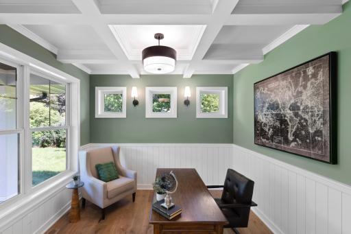 Main floor office features transom windows, coffered ceilings and wainscoting.