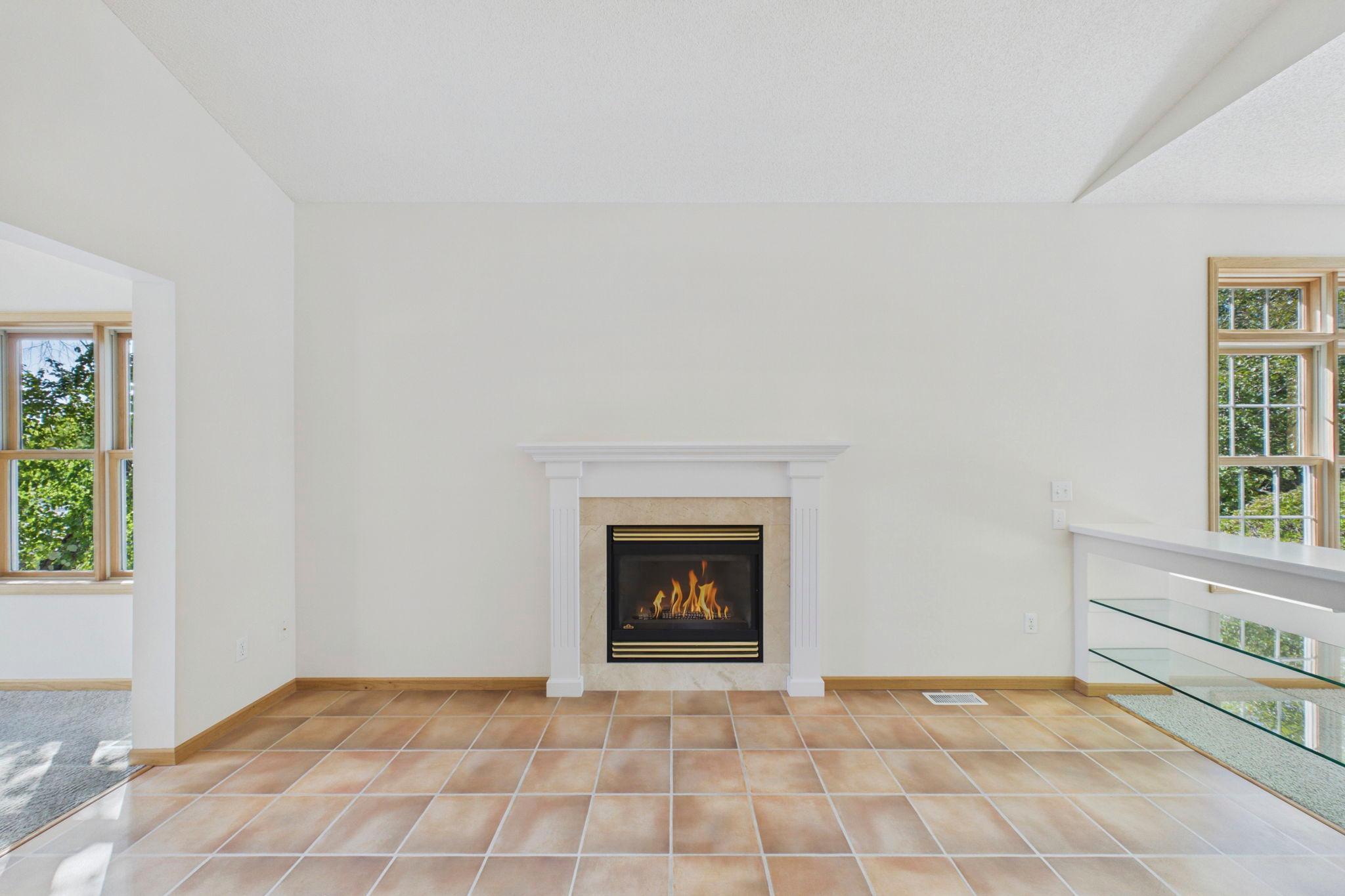 Fireplace area filled with natural light and open to the surrounding main-level living spaces.
