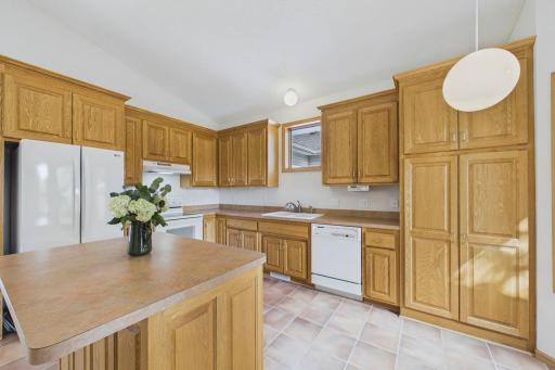 The kitchen’s center island adds prep space and storage, with windows bringing in plenty of natural light.