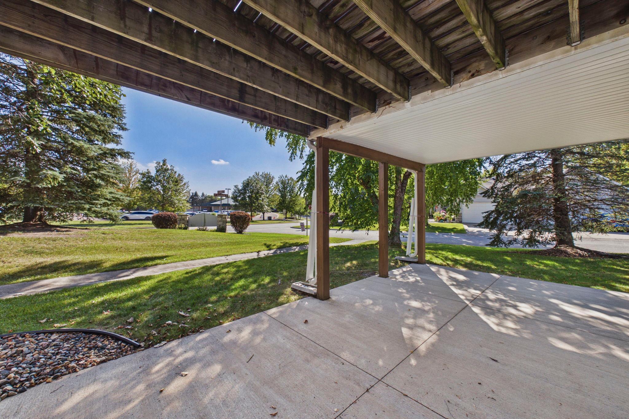 Walkout lower level opens to a covered patio and green space-an added extension of the home’s living space.