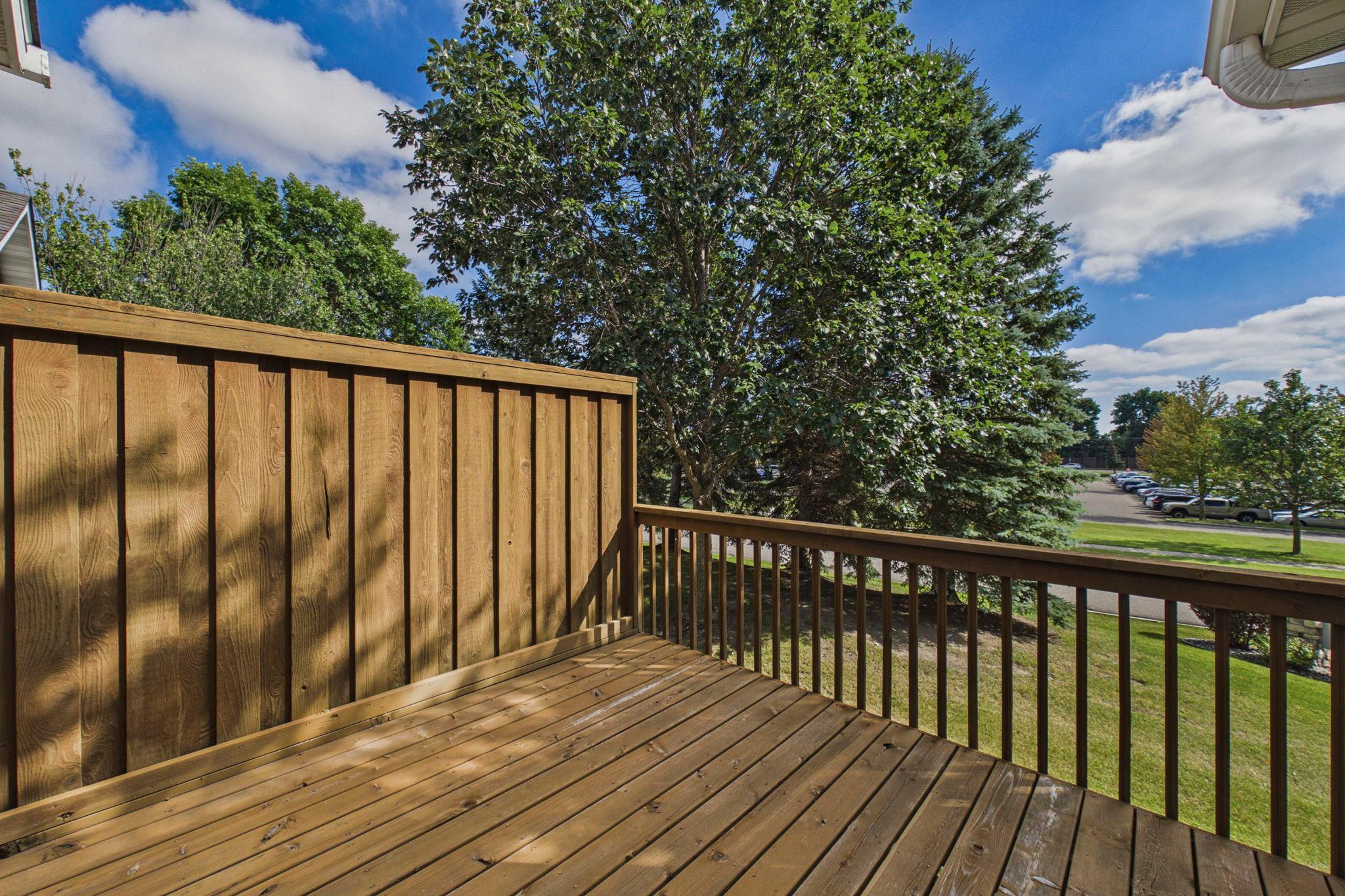 Enjoy outdoor living on the deck, with mature trees adding shade and greenery to the setting.