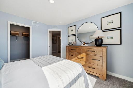Each of the home's secondary bedrooms on the upper level come perfectly sized and all feature their own private walk-in closet. Photo is of previously built model home, finishes, selections will vary.