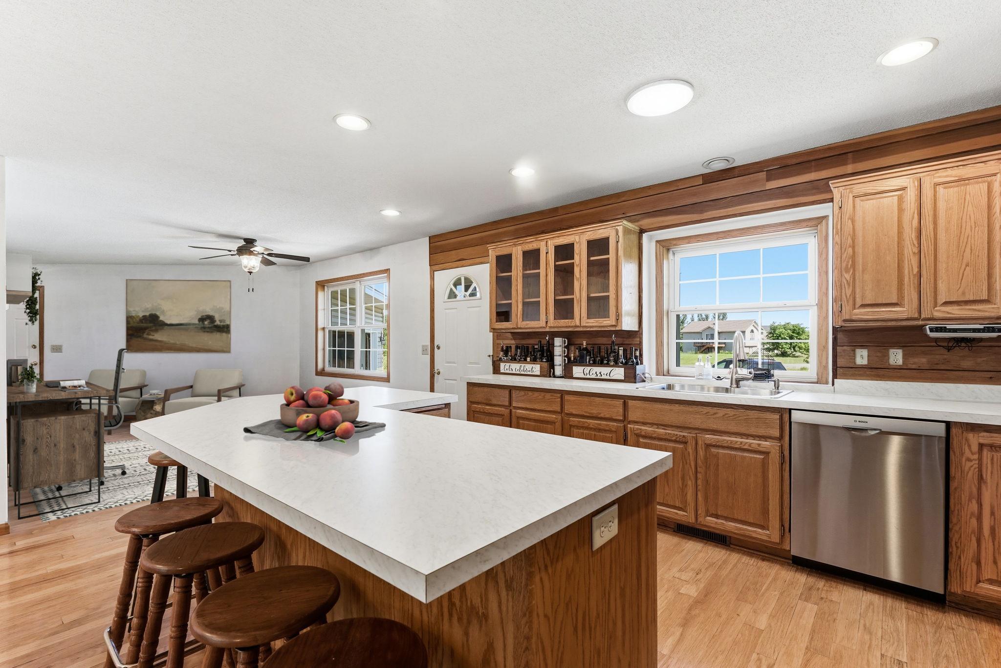 Virtually staged to show how the space next to the kitchen and entry way can be used