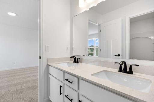 This Jack-and-Jill bathroom connects two bedrooms on the second floor, with dual sinks to accommodate shared living.