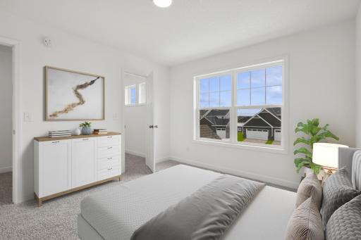 (Photo of a decorated model, actual finishes will vary) The second generously sized upper level secondary bedroom with a spacious walk in closet.