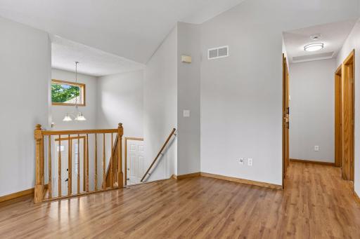 Two story foyer opens to main staircase.