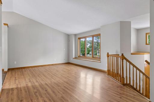 Bright and airy vaulted upper level with open concept floor plan between the living room, dining and kitchen.