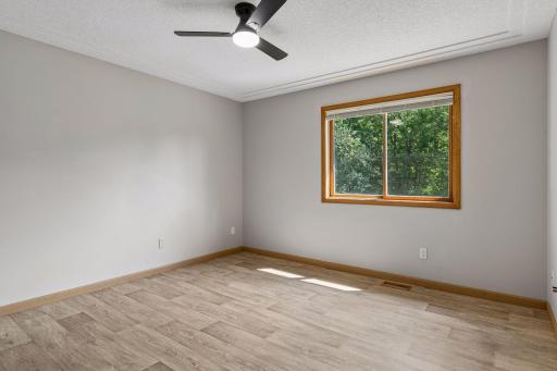 Upper primary suite with track ceiling, updated lighting and flooring.