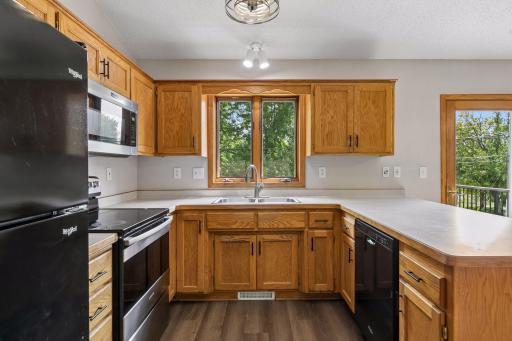 Kitchen window overlooks backyard.