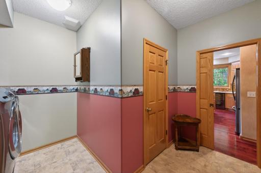 Entrance to the laundry room and access to the kitchen and LARGE pantry. Primary bedroom is just trough the door and to you right. SO CONVENIENT!