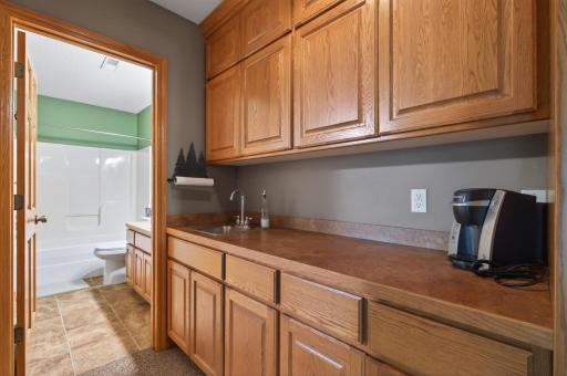 Abundance of countertop and storage in the wet bar area.