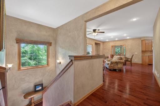 The welcoming front entry features rich hardwood flooring, soaring ceilings, and abundant natural light that highlights the spacious main-level living areas.