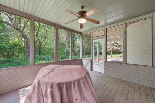 Enjoy the outdoors in comfort from this spacious screened porch overlooking a private, wooded backyard. Surrounded by mature trees and abundant wildlife, this inviting retreat offers the perfect place to relax with a morning coffee of to just unwind
