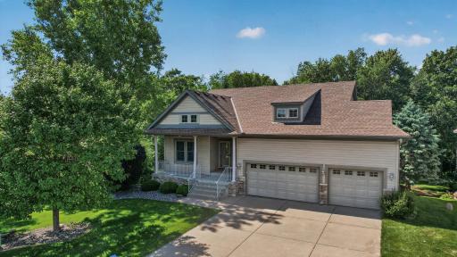This attractive home features a welcoming covered front porch, oversized 3-car garage, and exceptional curb appeal with mature landscaping.