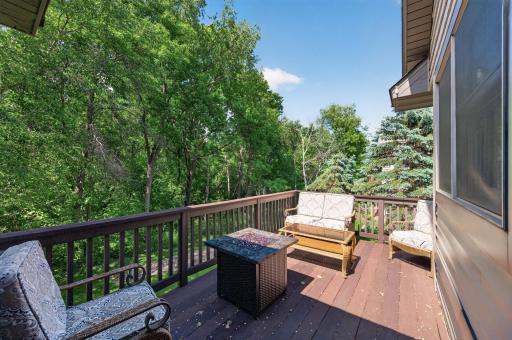 The spacious deck which is accessed through the 4 seasons porch offers plenty of room for outdoor seating, grilling, and gatherings while overlooking a beautifully landscaped yard.