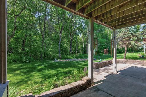 Step outside to a private patio retreat nestled against a backdrop of mature trees and protected green space.
