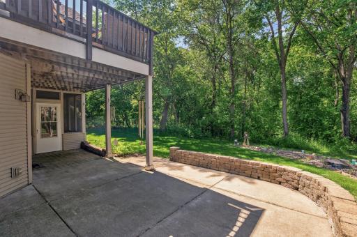 Located just off the screened porch and walkout lower level, this inviting outdoor living area is perfect for relaxing, entertaining, or simply enjoying the peaceful surroundings.