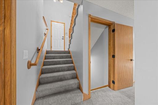 Stairway leading from main level foyer to 1st "Lower Level" Walk-out - This level Features a 4th bedroom, Full bath laundry, & Large Family/Entertainment room