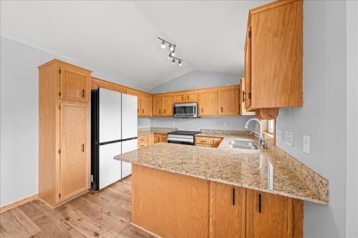 Kitchen with ample counter and storage space plus newer dishwasher, refrigerator and oven/range!