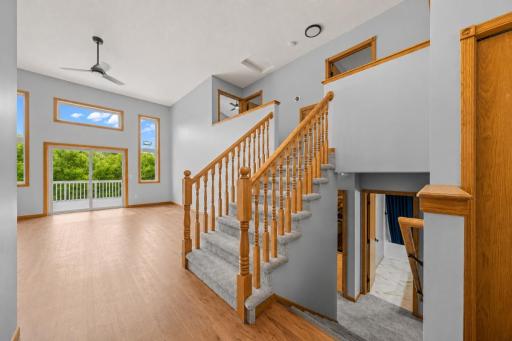 View of living room and staircase to Upper & Lower Levels from the Foyer.