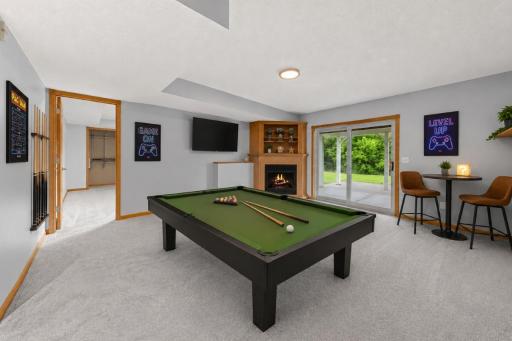 Spacious rec room with cozy gas burning fireplace in basement - Virtually Staged!