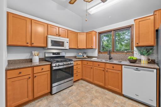 A large window above the sink fills this inviting kitchen with natural light, creating a bright and welcoming space for daily living.