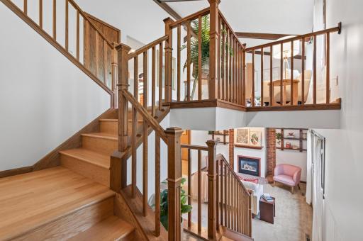 Beautifully crafted wooden stairs and railings create a stunning focal point in this inviting split-level home