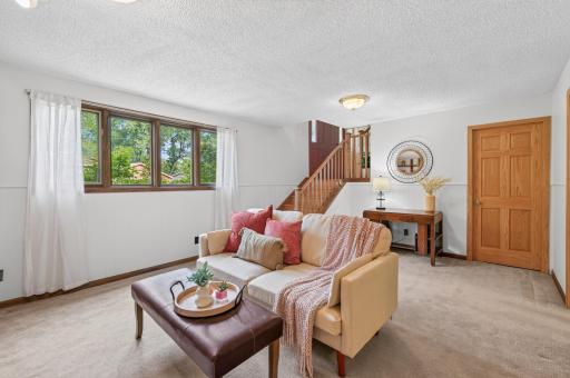 Unlike typical basements, this finished space is flooded with natural light, offering a comfortable and airy living area.