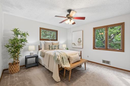 Filled with natural light, this serene and peaceful primary bedroom offers a peaceful retreat to unwind and recharge.