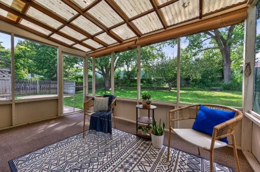 Screened porch, covered patio great for those sunny days and a cup of coffee listening to the rain fall. A perfect view overlooking the backyard, offering a relaxing outdoor space perfect for enjoying serene view.