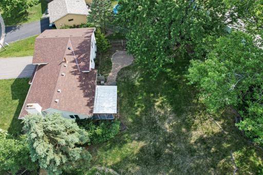 Surrounded by lush greenery and mature trees.