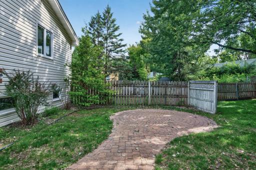 Paved patio area offering a simple outdoor space for seating, grilling, or relaxing by the fit pit.