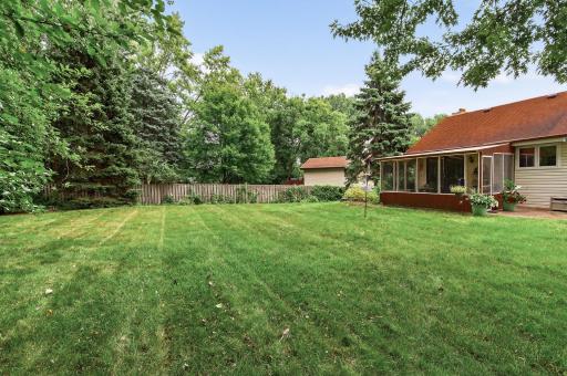 Surrounded by lush green trees, offering a peaceful and private outdoor setting