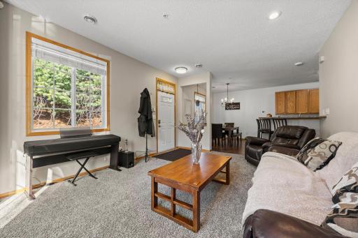The comfortable living room offers plush carpeting and a cozy Heat-N-Glo fireplace, perfect for everyday living or gathering with guests.