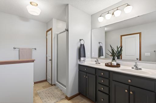 Primary bathroom featuring updated vanity cabinetry and ample storage.