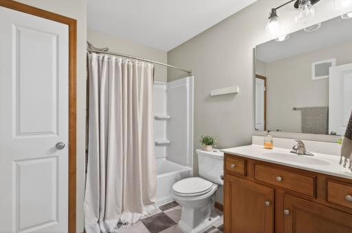 Full upper-level bathroom with updated flooring and lighting