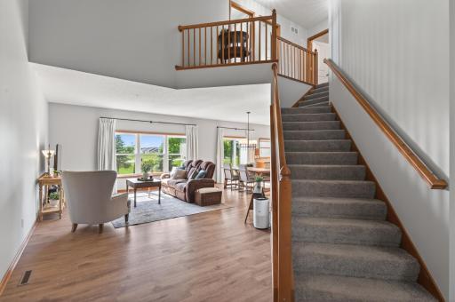 Open staircase and loft overlook create an airy, spacious main living area.
