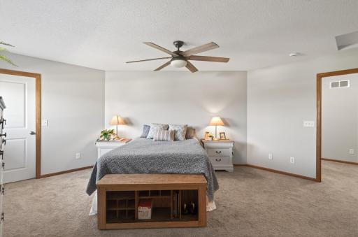 Spacious primary bedroom with generous layout and updated ceiling fan.