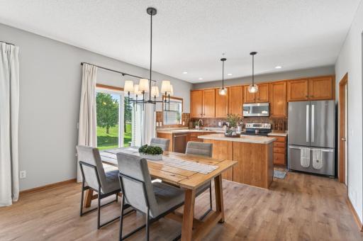 Open-concept dining area with sliding glass door to the backyard.