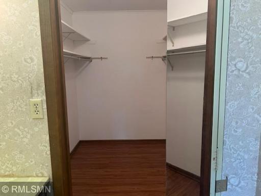 Private master walk-in closet with new vinyl-plank flooring.