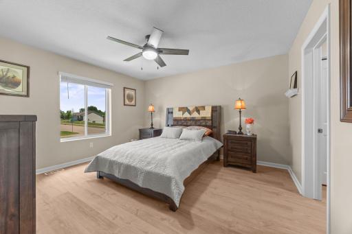 Primary ensuite bedroom with new floors, walk-in closet, and full bathroom.