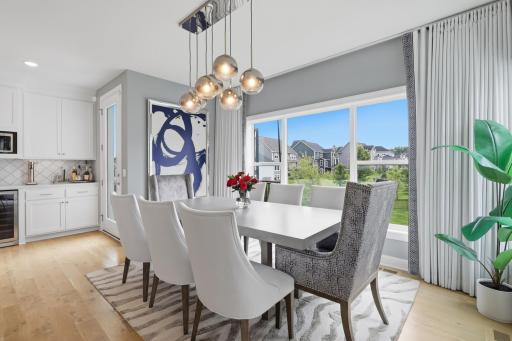 Dining area with stunning light fixture and large window to let the light in.